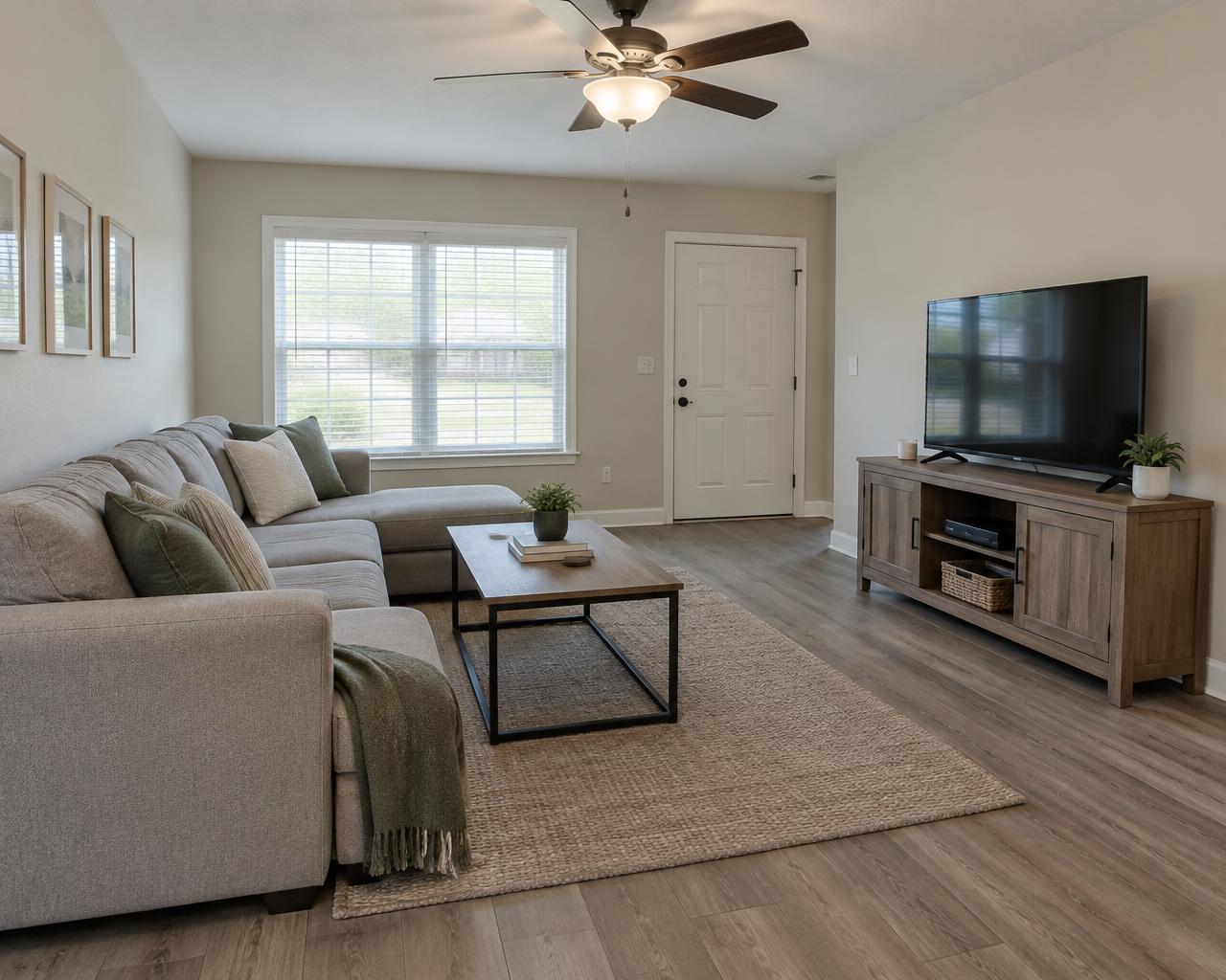 Comfortable residential living space with bright finishes and wood-look flooring